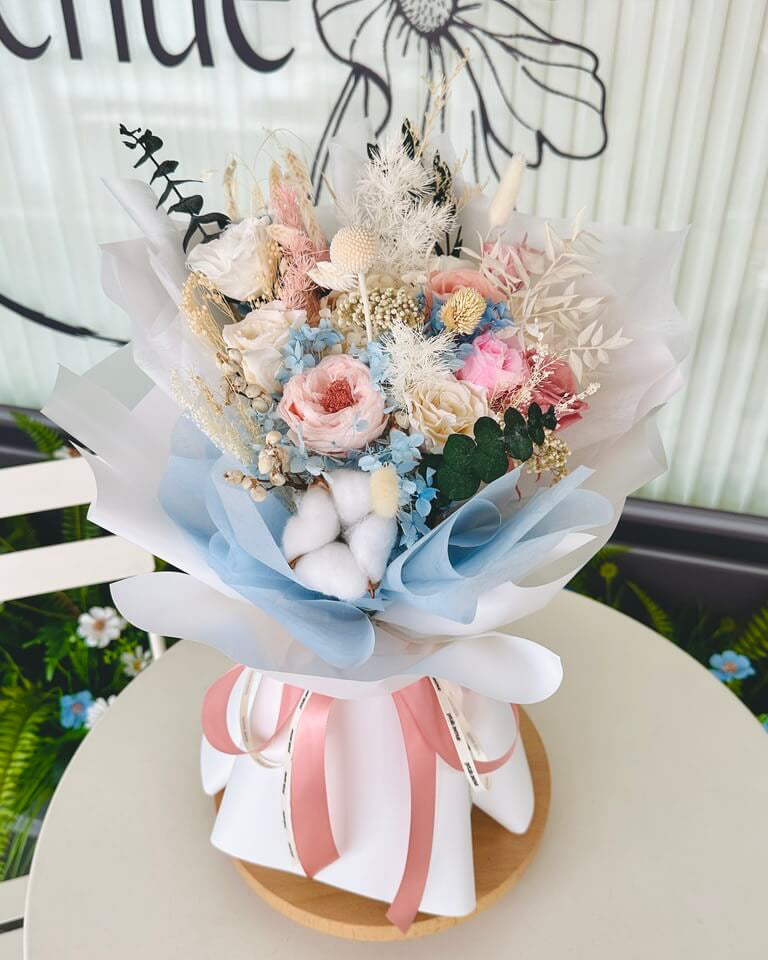 Delicate blue and pink everlasting flowers clustered together in a visually pleasing bouquet