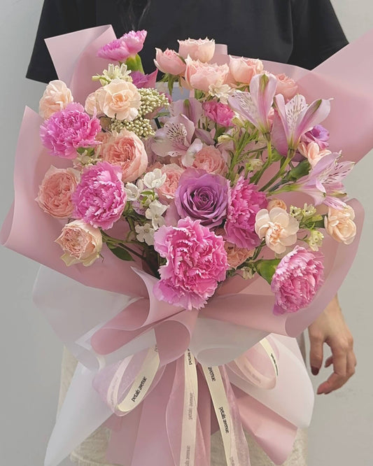 Delicate floral arrangement in Soft and Light theme, featuring carnations and spray roses in a romantic pastel palette.