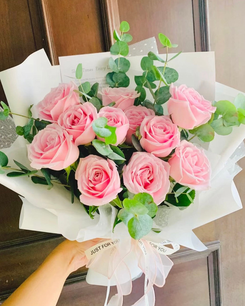 Pink rose bouquet beautifully wrapped, ready for gifting.