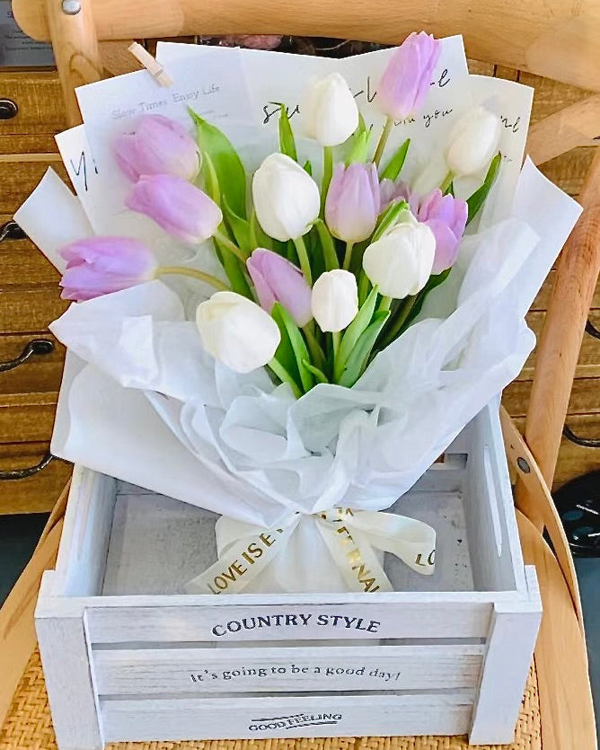 Close-up of fresh tulips with bright petals, available in various colors.