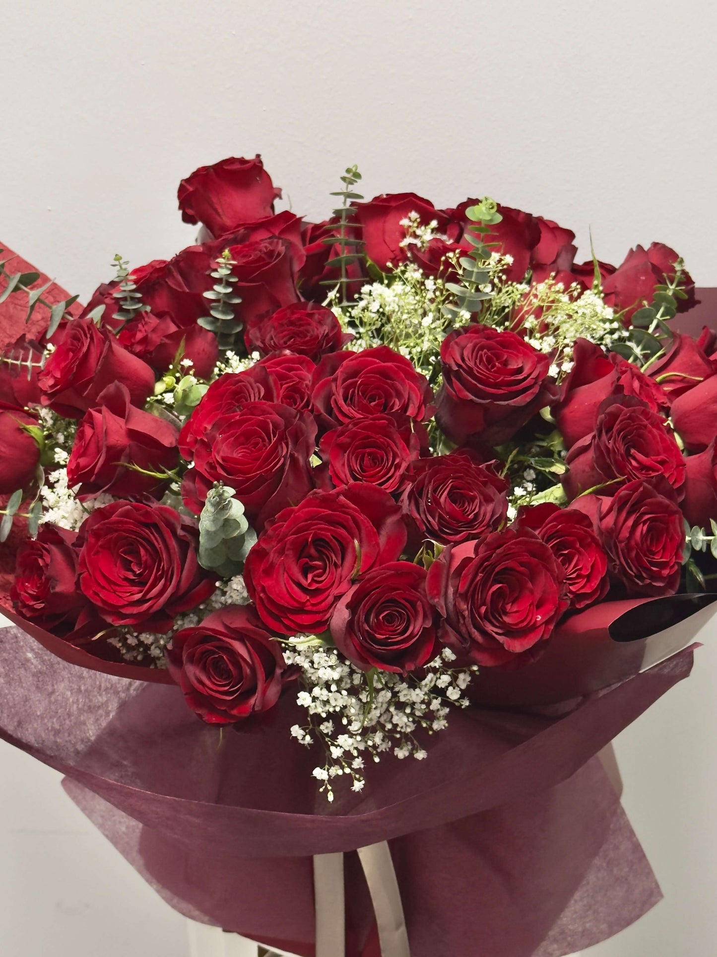 50 red roses with splendid filler flowers