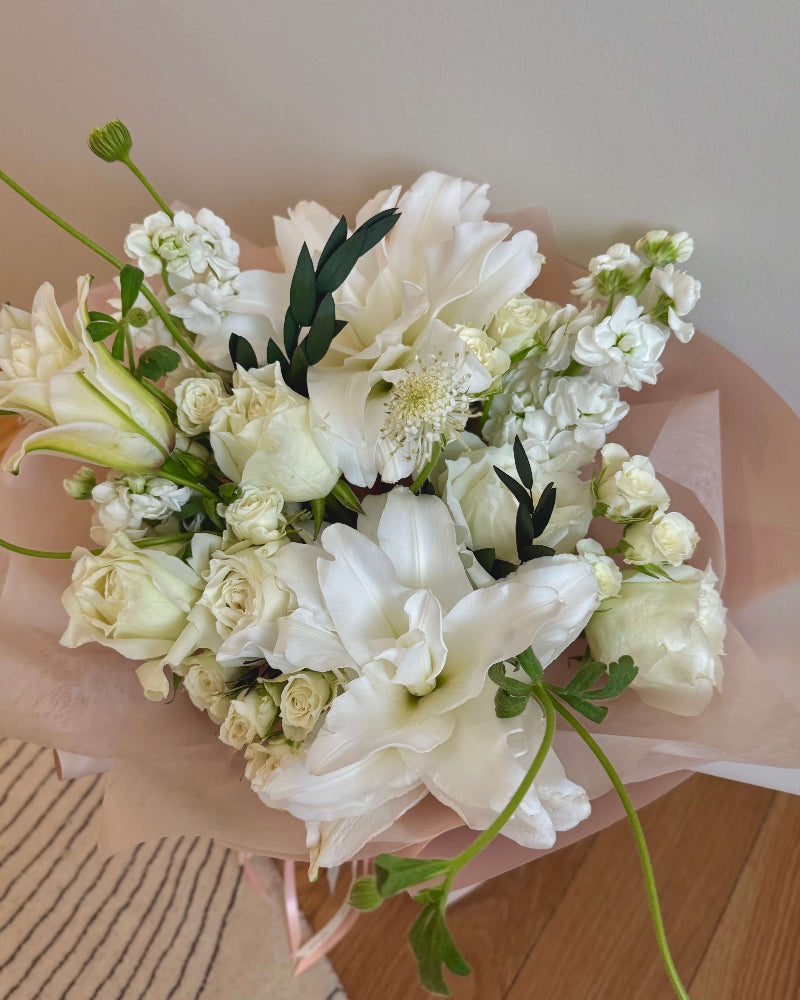 Modern Omakase lily bouquet styled with elegant neutral flowers