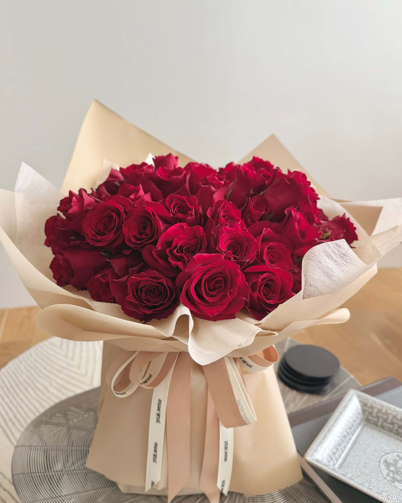 pull back shot of beautiful vibrant red roses