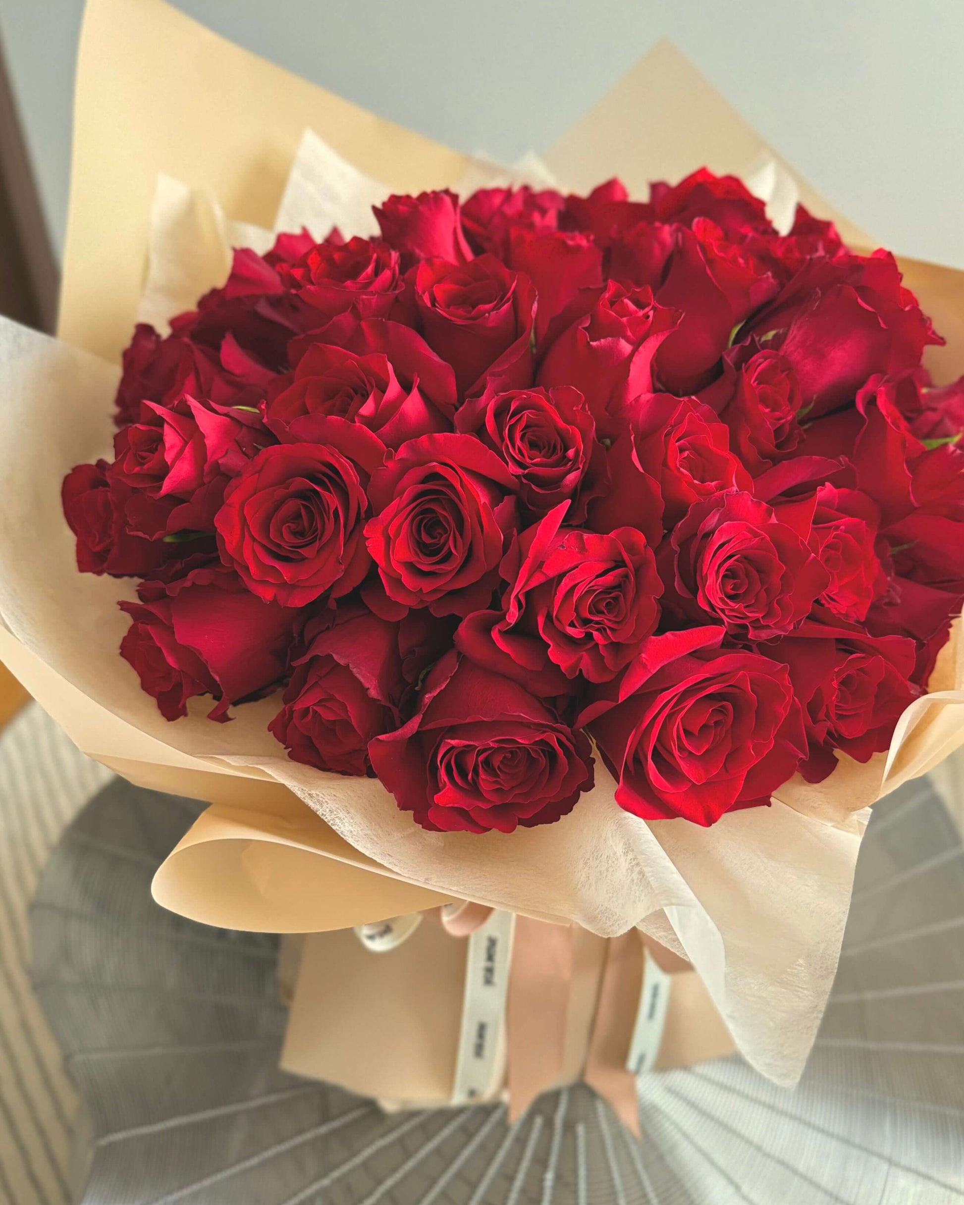 Elegant bouquet of deep red roses with splendid filler flowers, beautifully arranged for a romantic gift