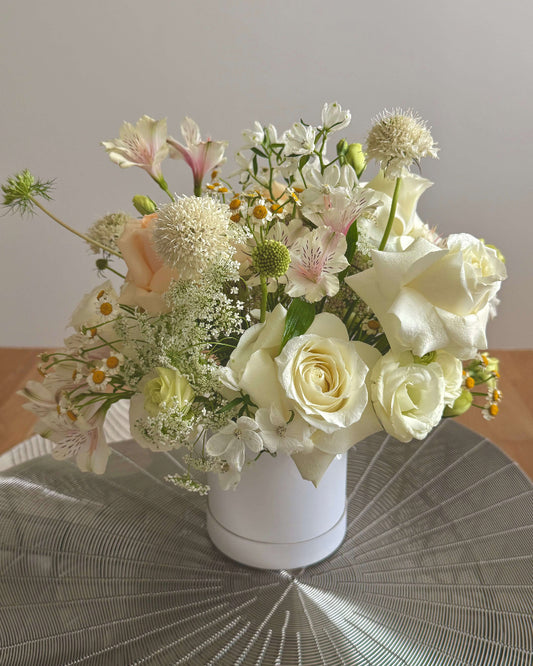 Light-themed Omakase Bloom Box with soft, pastel-colored flowers and gentle greenery, perfect for subtle elegance.