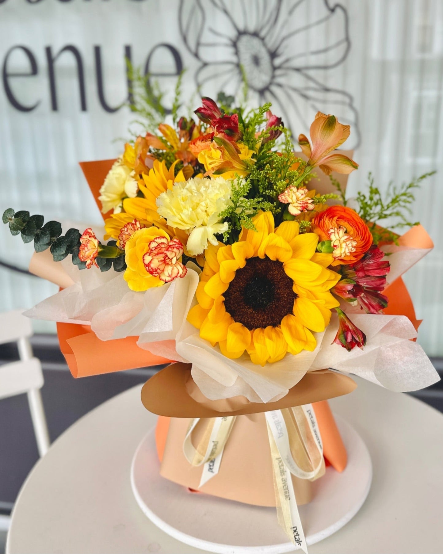 Image of sunflowers, tulips, and filler flowers in a Bright and Vibrant floral arrangement