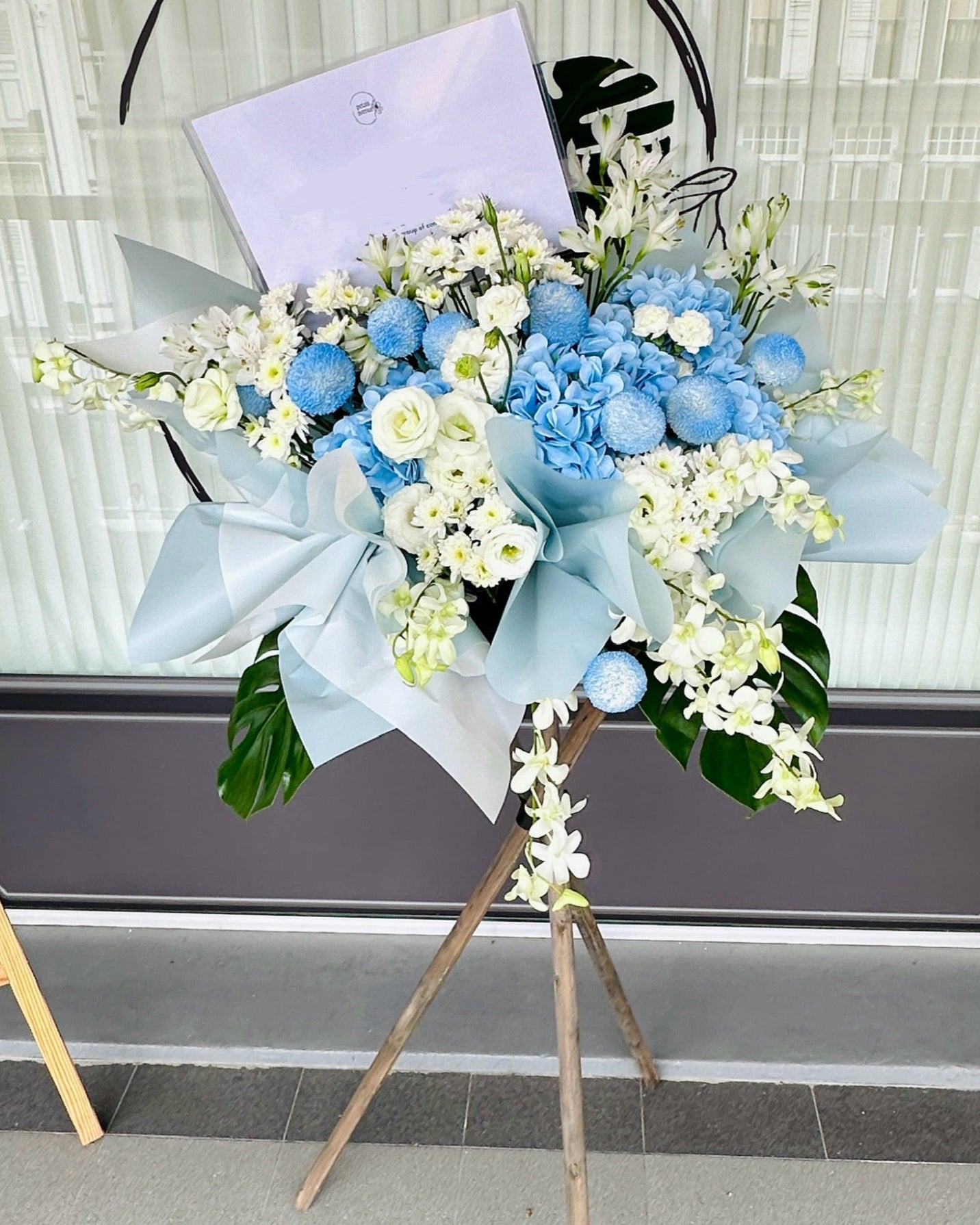 blue and white flower stand with orchids