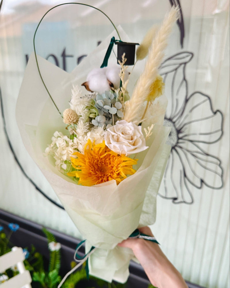 Preserved teddy bear sunflower with bright petals, acting as the centerpiece of the bouquet