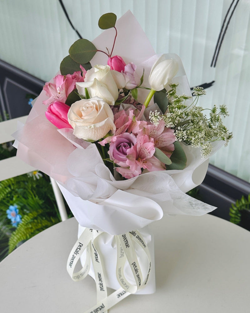 Cheerful and stylish petite tulip bouquet with seasonal blooms and vibrant filler flowers.