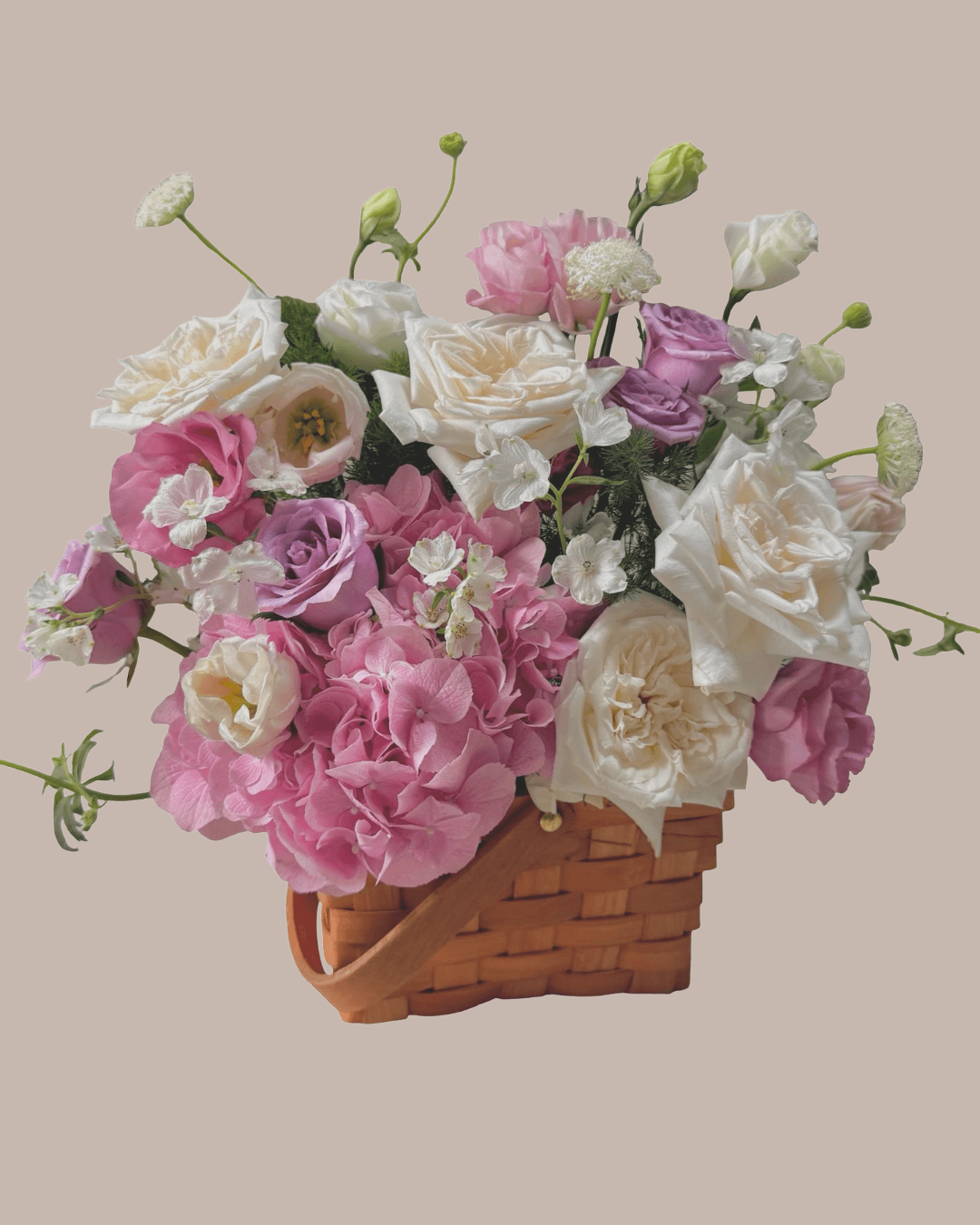 Floral arrangement in a woven basket done by one of the private students