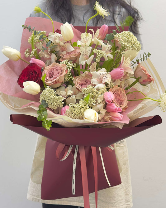 Warm-toned tulip bouquet with autumn-inspired hues, accented with Chic fillers in an earthy, romantic palette