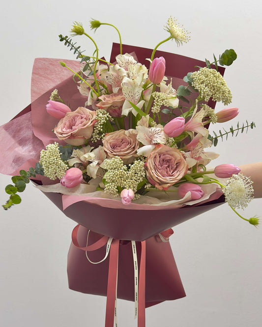 bright and vibrant Omakase Tulip Bouquet with rich, warm-toned tulips and dark wrap