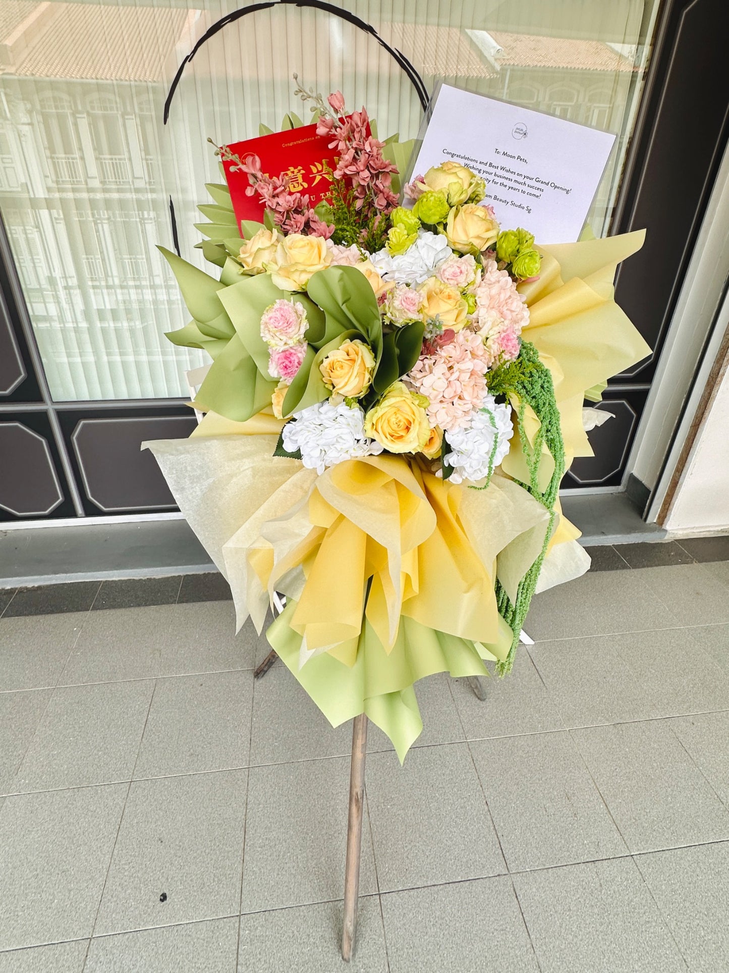 Cheerful Well Wishes Green and Peach Flower Stand