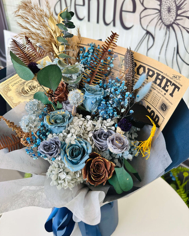 Whimsical bouquet in Ravenclaw colors with magical-themed items and preserved flowers.