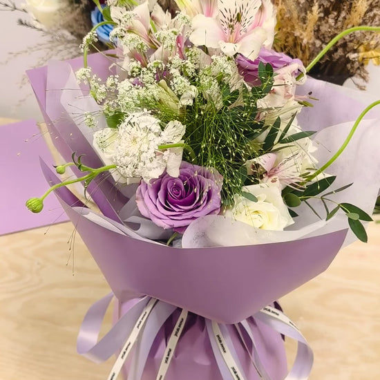 Light and soft styled bouquet featuring a mix of seasonal blooms with Chic filler flowers.
