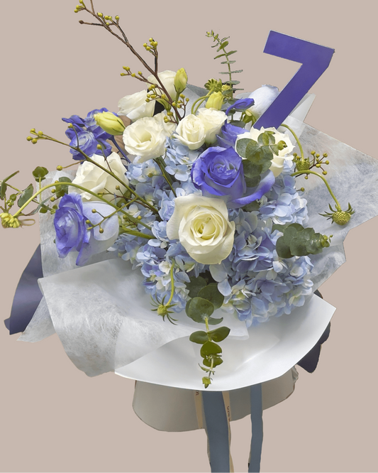 a blue and white theme bouquet of hydragea and roses 